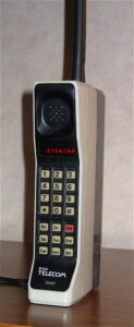 A Motorola DynaTAC 8000X from 1984. This phone has an early British Telecom badge and primitive red LED display.